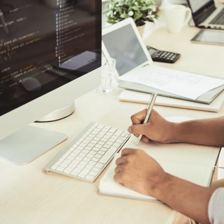 Businessman working at the table on computer in IT office